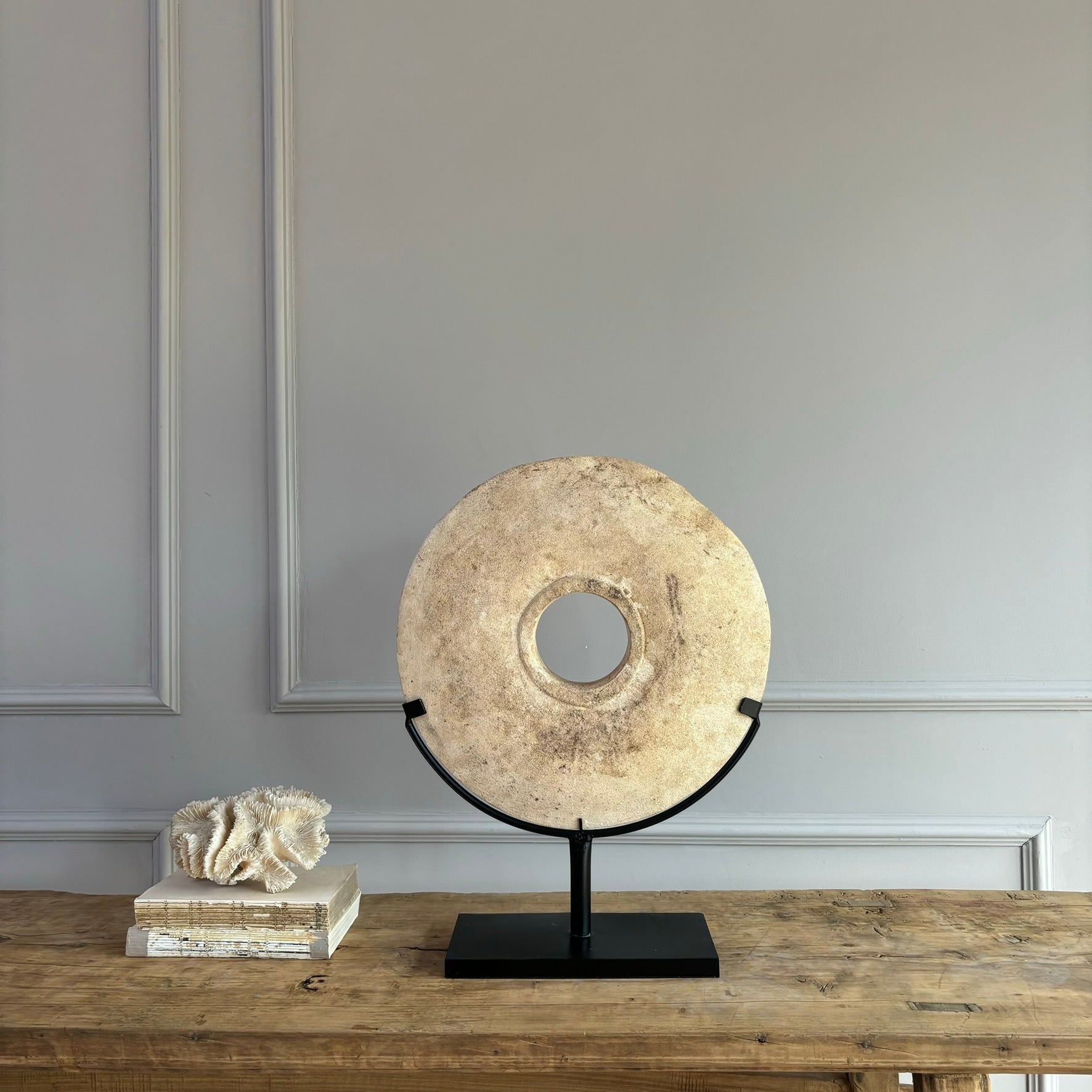 Large sandstone disc on stand