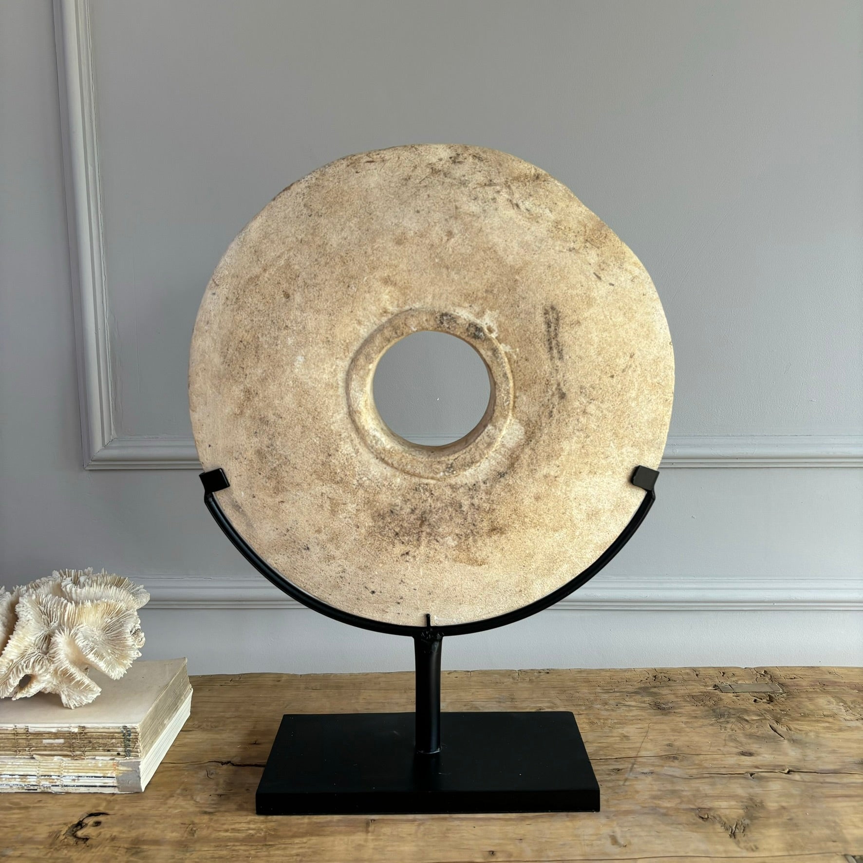 Large sandstone disc on stand