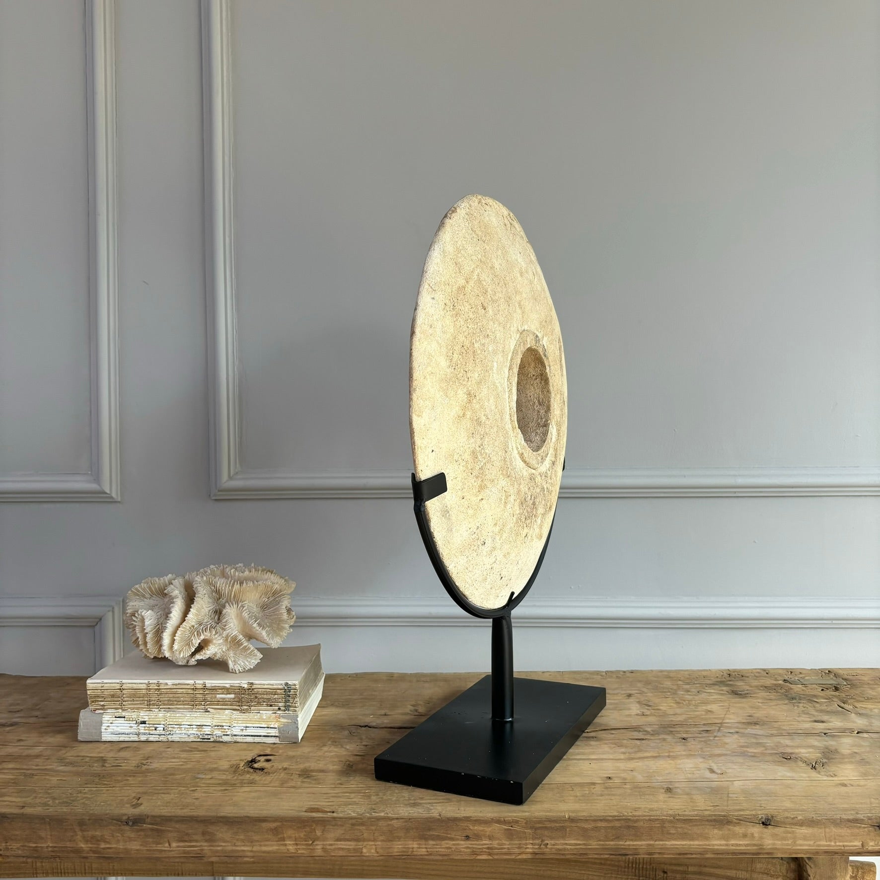 Large sandstone disc on stand