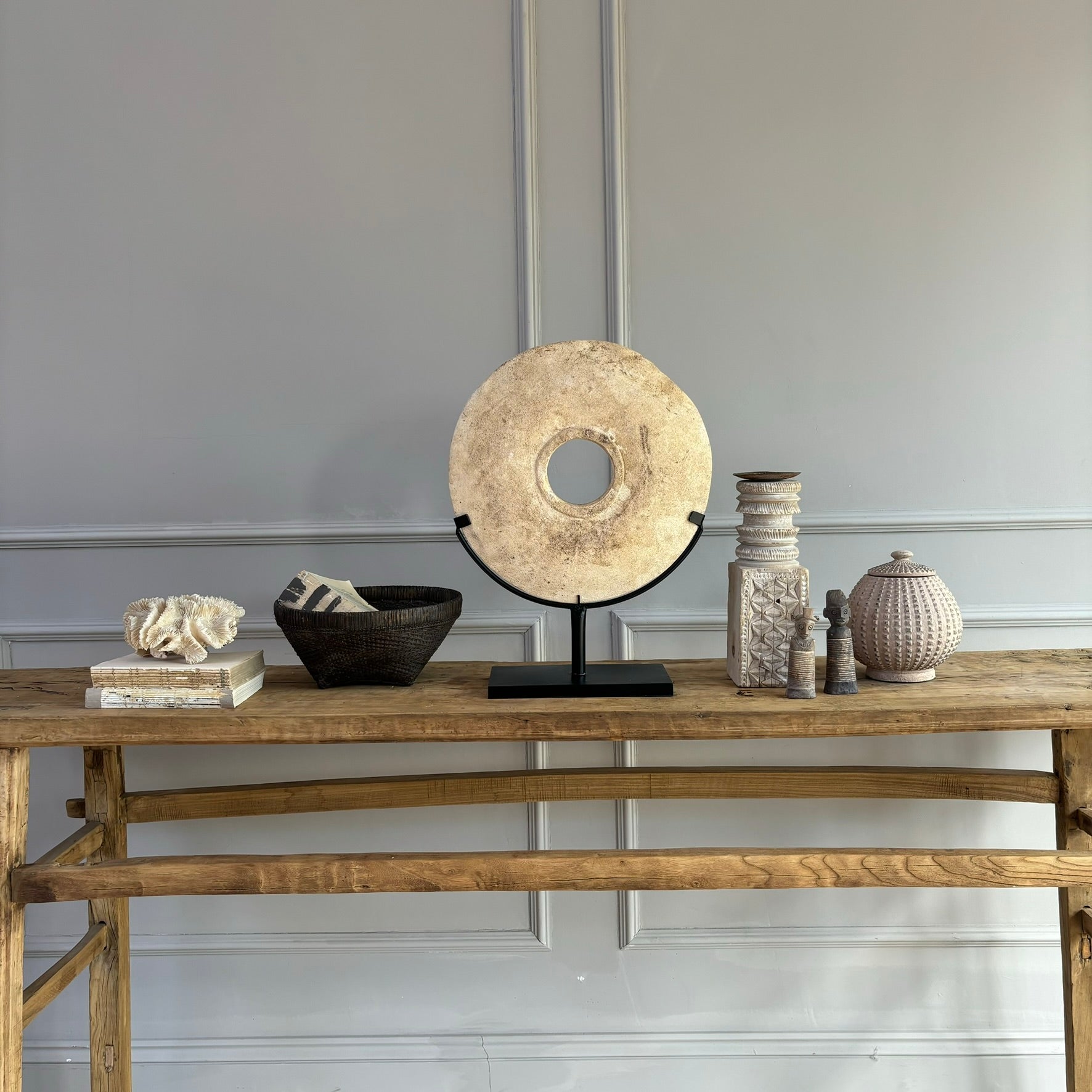 Large sandstone disc on stand